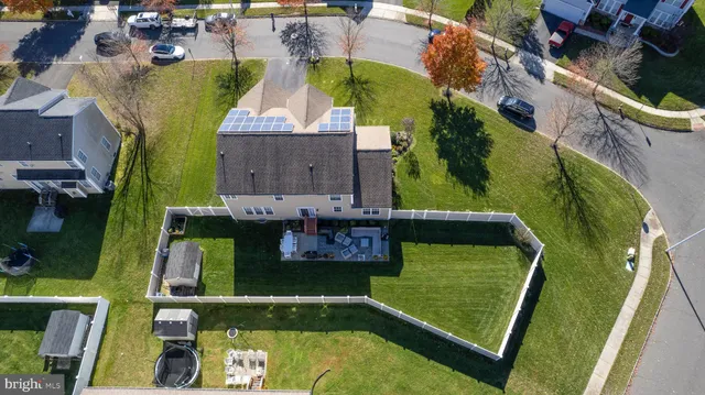 an aerial view of a house with a garden and lake view