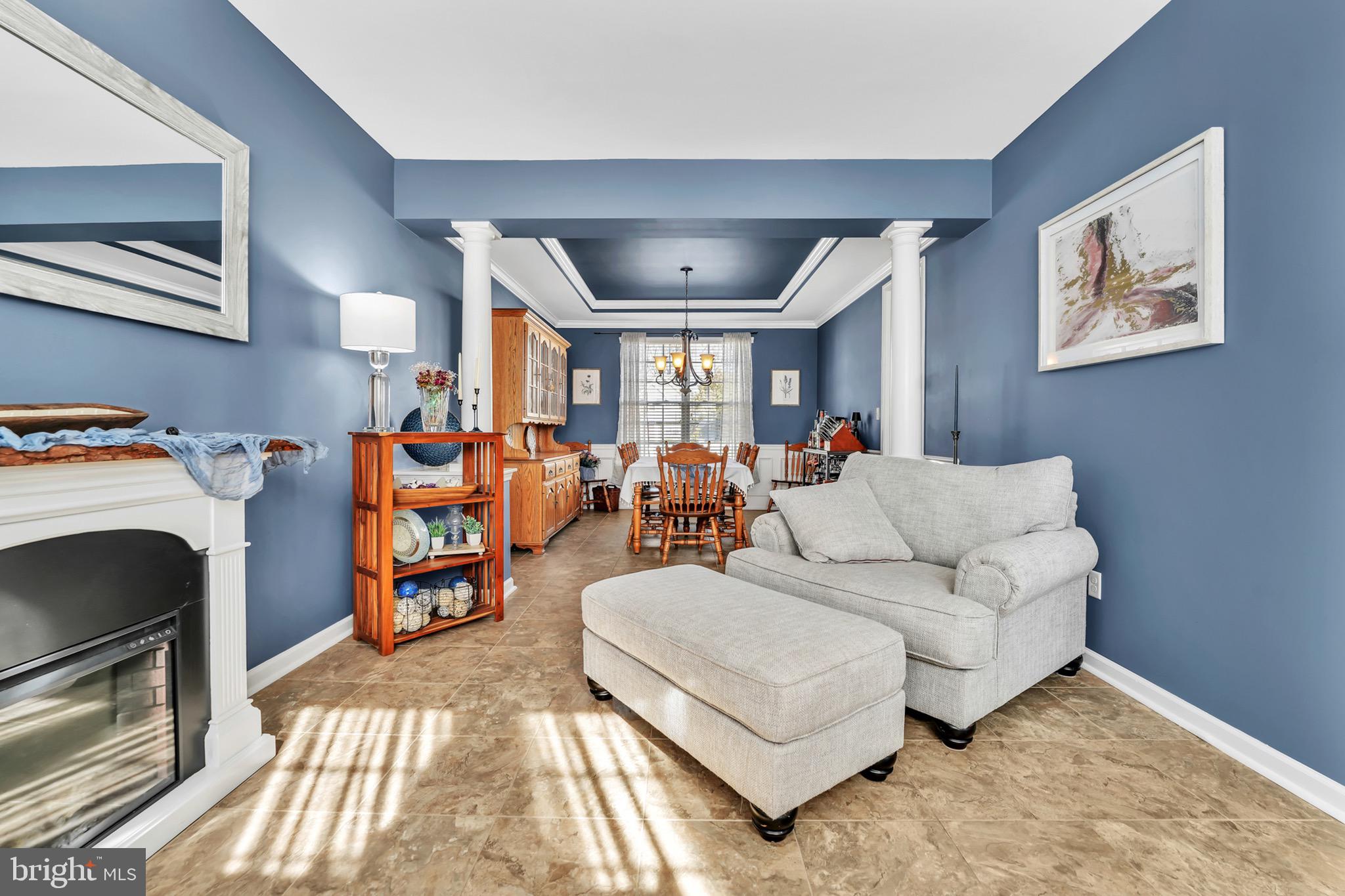 63 Homestead Drive Pemberton, NJ 08068 - Photo 6 of 46 a living room with furniture a couch and paintings on the wall