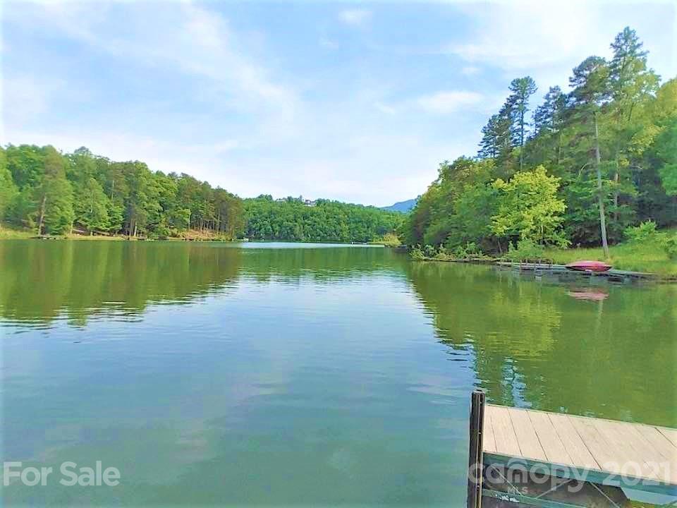 0 Pointe Ln Mill Spring, Unit 8 Mill Spring, NC 28756 - Photo 10 of 19 a view of a lake with a yard and large trees