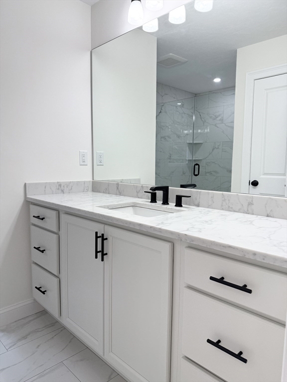 26 Marlyn Road Billerica, MA 01821 - Photo 13 of 36 a bathroom with a sink and a mirror