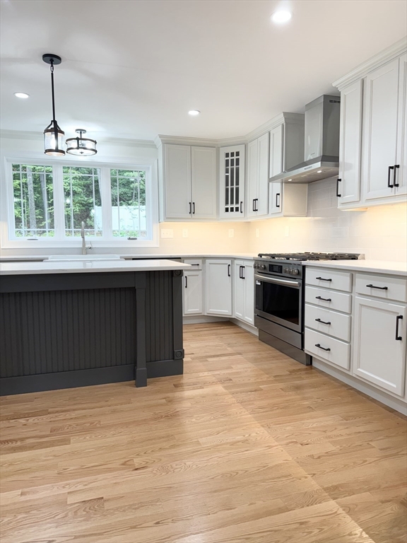 26 Marlyn Road Billerica, MA 01821 - Photo 4 of 36 a kitchen with stainless steel appliances granite countertop a stove a sink dishwasher and a refrigerator with wooden cabinets