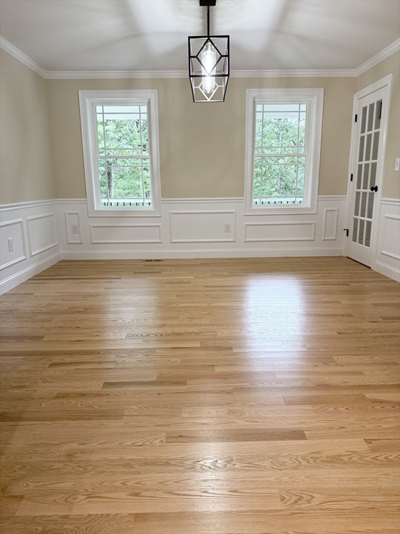26 Marlyn Road Billerica, MA 01821 - Photo 6 of 36 an empty room with wooden floor exposed radiator and windows