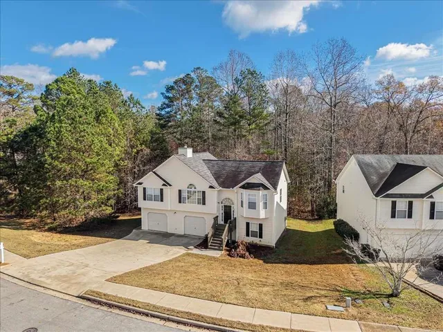 a view of a white house with a yard