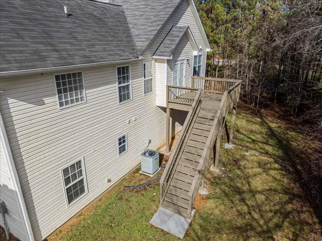 a view of wooden house with a yard