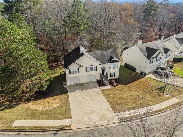 a view of a house with large trees