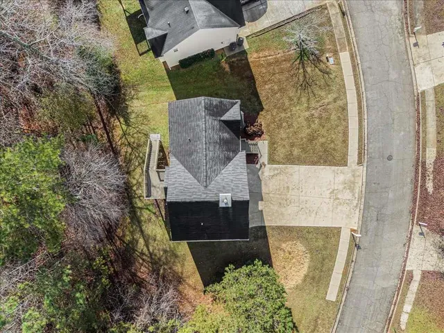 an aerial view of a house with a yard