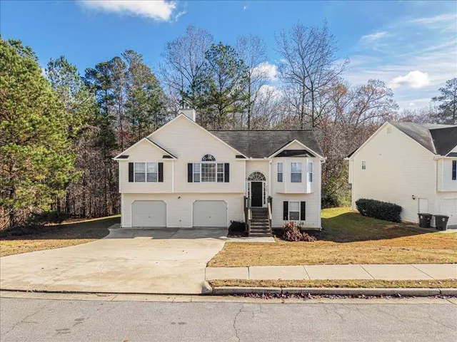 a view of white house with a yard