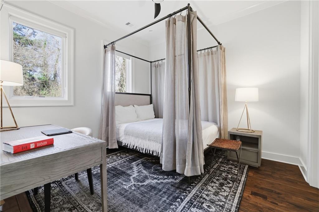 773 Lenox Lane Atlanta, GA 30324 - Photo 23 of 54 a bedroom with a bed table and a window