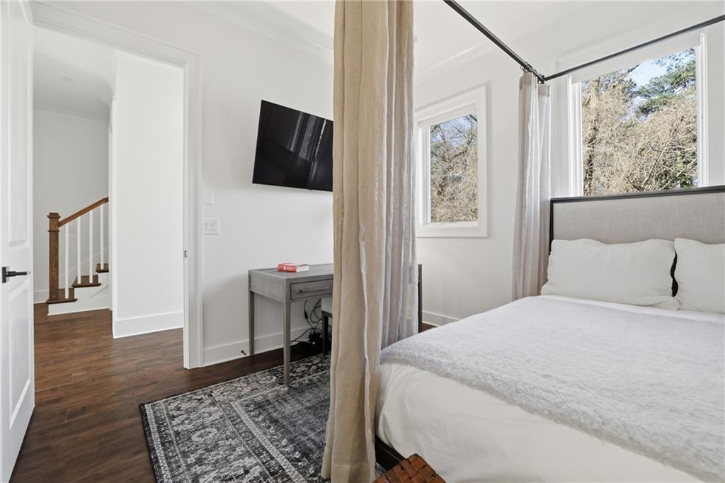 773 Lenox Lane Atlanta, GA 30324 - Photo 25 of 54 a bedroom with a bed and a painting on the wall