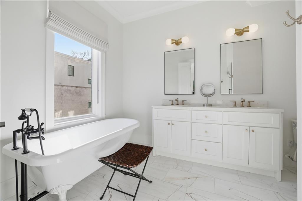 773 Lenox Lane Atlanta, GA 30324 - Photo 29 of 54 a bathroom with a sink vanity and mirror