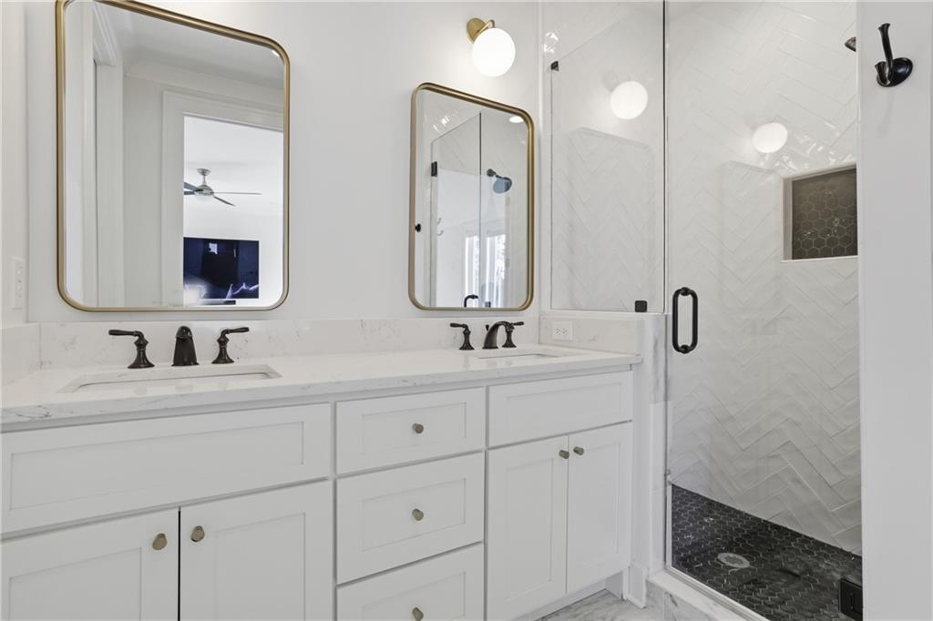 773 Lenox Lane Atlanta, GA 30324 - Photo 39 of 54 a bathroom with double vanity sink a mirror and shower