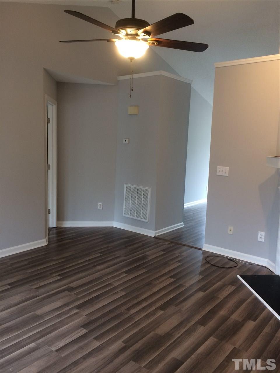 2305 Havering Place Raleigh, NC 27604 - Photo 5 of 10 a view of an empty room with wooden floor and a window