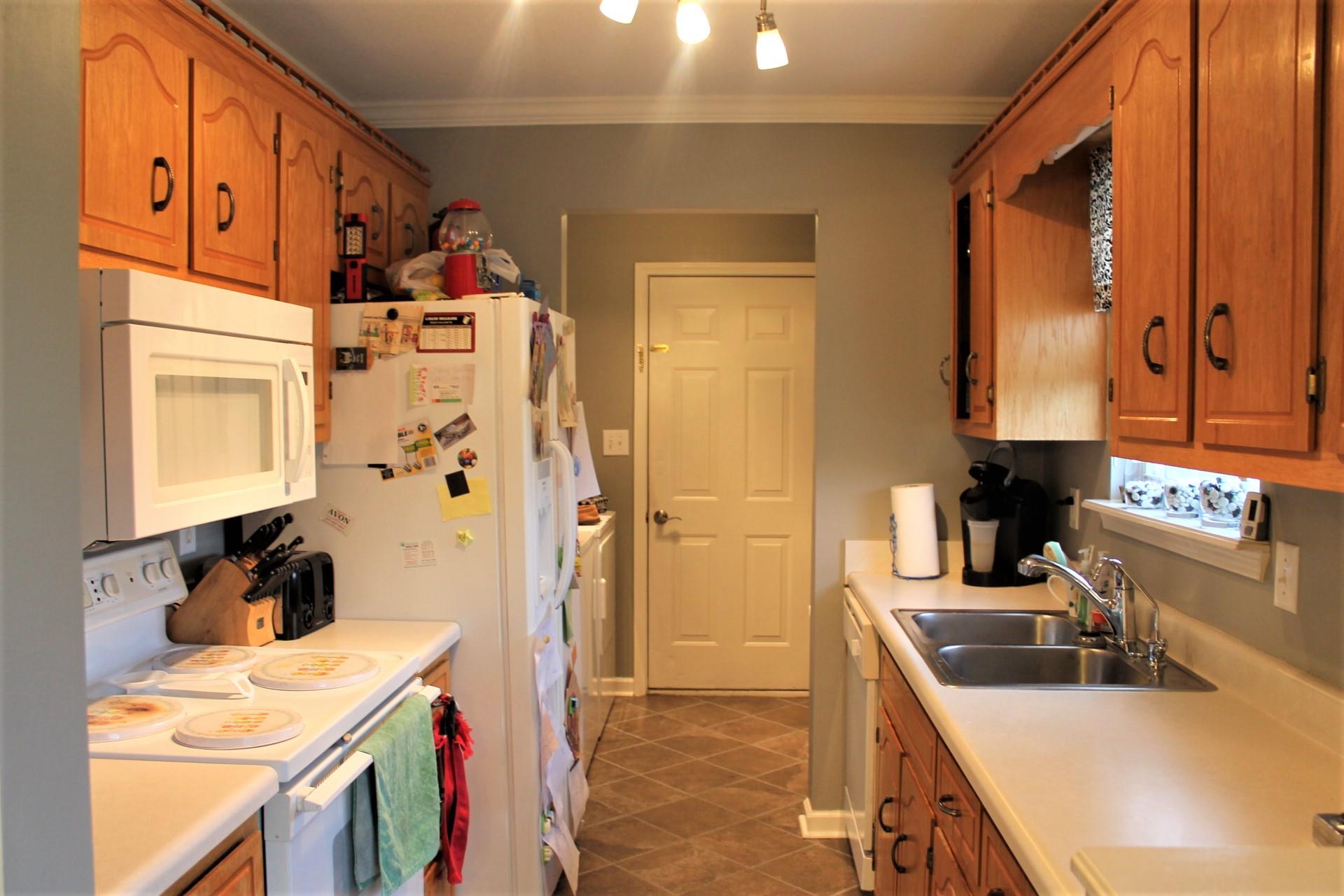 3389 Dailey Road Clarksville, TN 37042 - Photo 8 of 13 Kitchen leads to laundry room with pantry and shelving