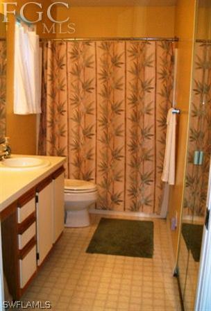 18513 Sunflower Road Fort Myers, FL 33967 - Photo 13 of 14 a bathroom with a granite countertop sink and a shower curtain
