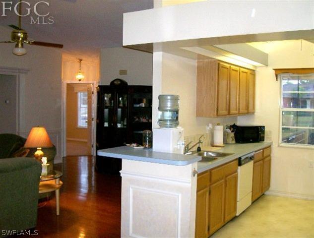 18513 Sunflower Road Fort Myers, FL 33967 - Photo 6 of 14 a kitchen with a sink appliances and cabinets