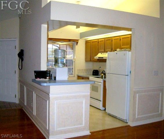 18513 Sunflower Road Fort Myers, FL 33967 - Photo 7 of 14 a kitchen with a refrigerator and a stove