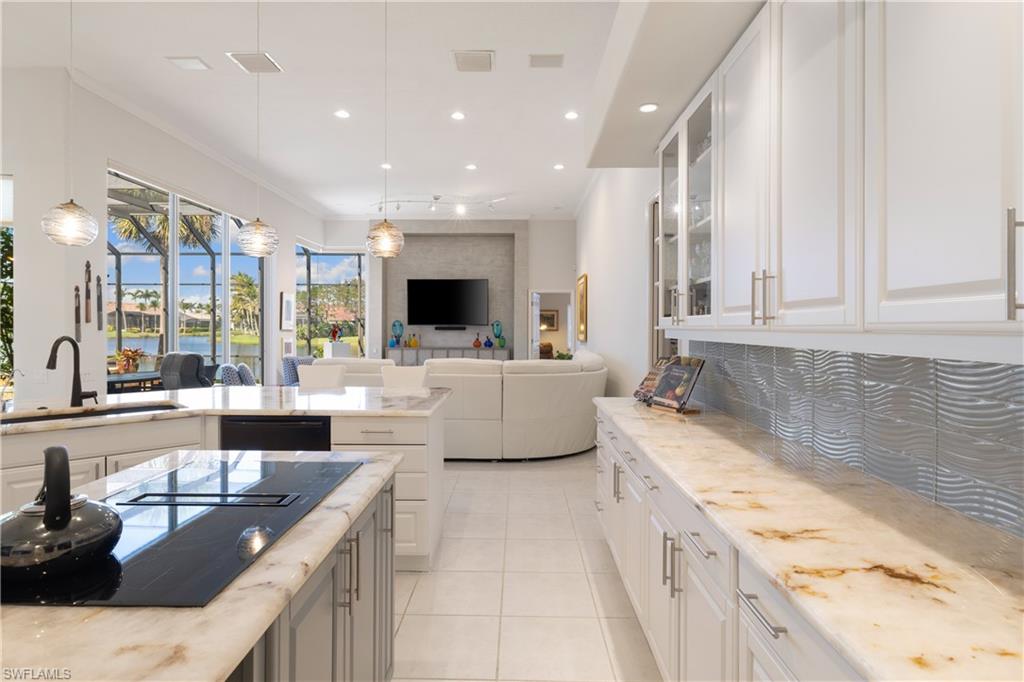11290 Compass Point Drive Fort Myers, FL 33908 - Photo 13 of 50 a large kitchen with stainless steel appliances kitchen island granite countertop a sink and cabinets