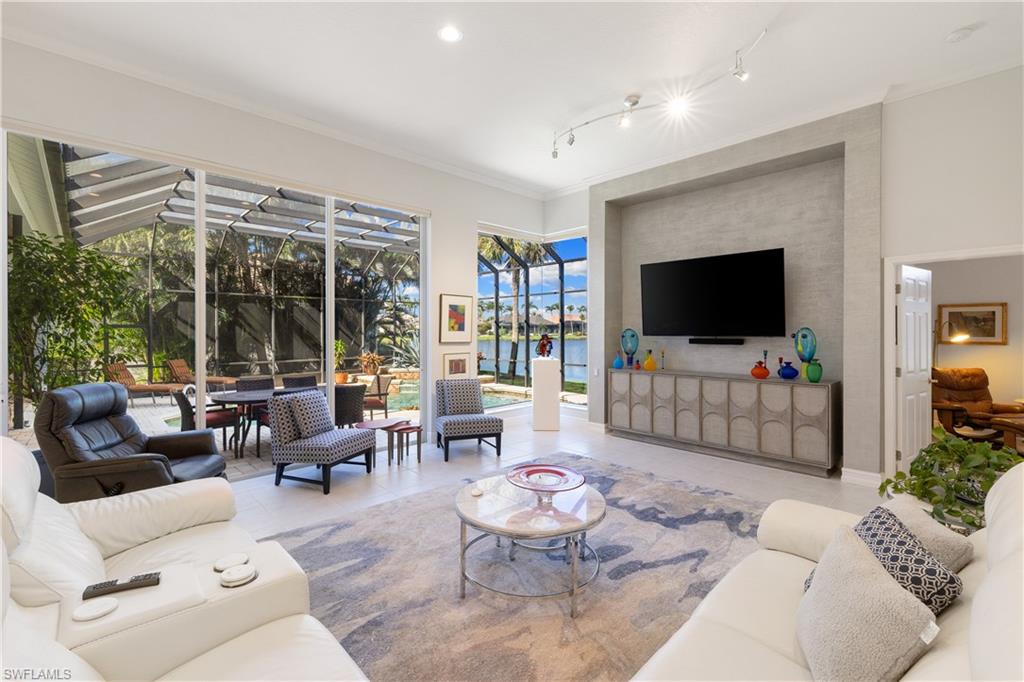 11290 Compass Point Drive Fort Myers, FL 33908 - Photo 16 of 50 a living room with furniture and a flat screen tv