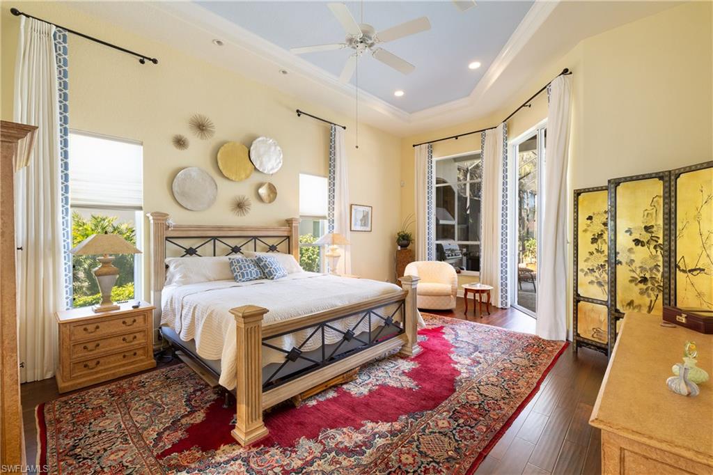 11290 Compass Point Drive Fort Myers, FL 33908 - Photo 22 of 50 a bedroom with a bed and wooden floor