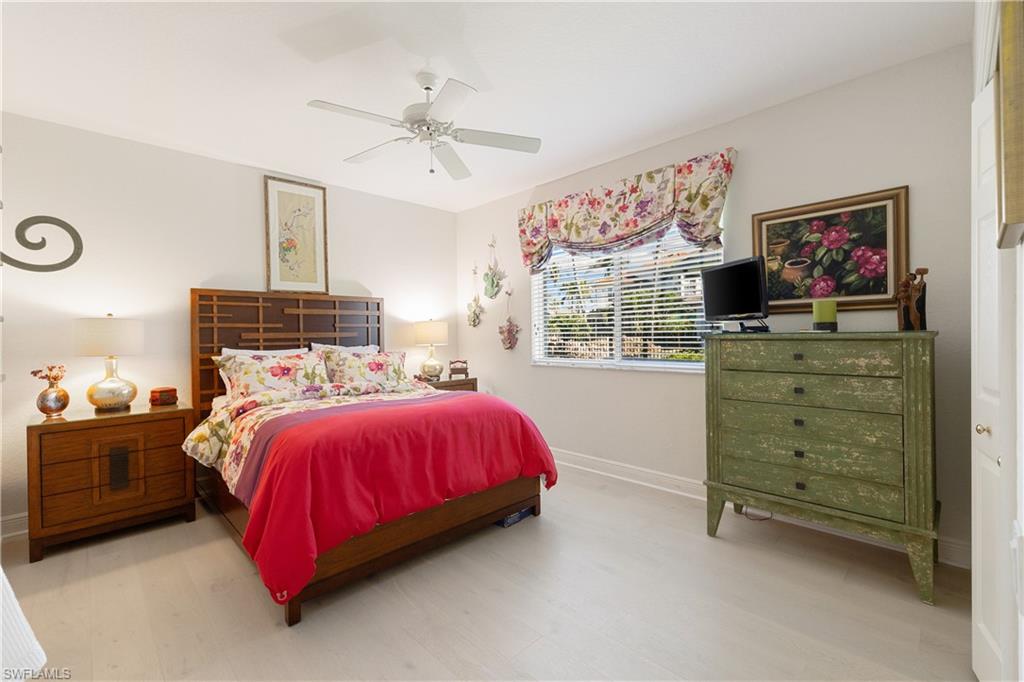 11290 Compass Point Drive Fort Myers, FL 33908 - Photo 32 of 50 a bedroom with a bed and a flat tv screen on dresser