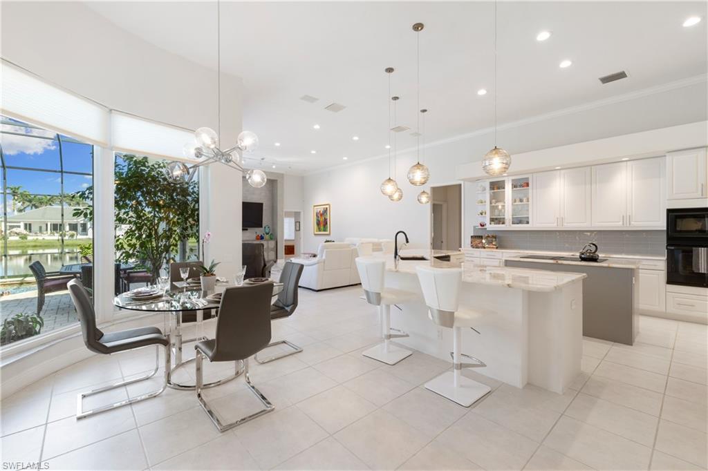 11290 Compass Point Drive Fort Myers, FL 33908 - Photo 8 of 50 a living room with lots of white furniture and a table