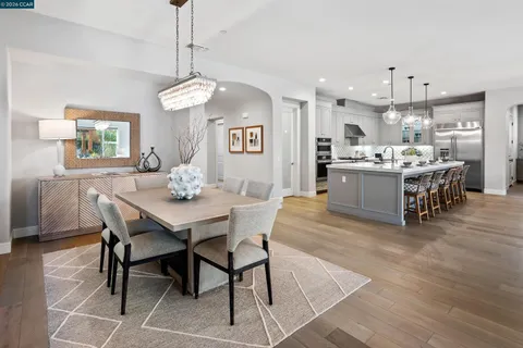 a kitchen that has a dining table and chairs
