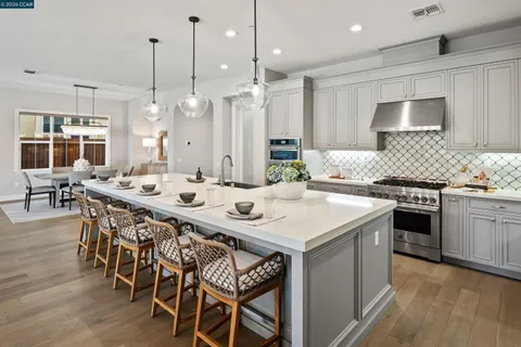 a kitchen with granite countertop a stove and a sink