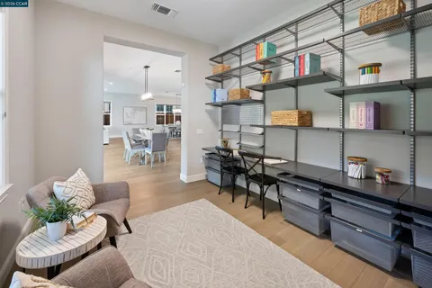 a spacious bedroom with a bed a couch and a window