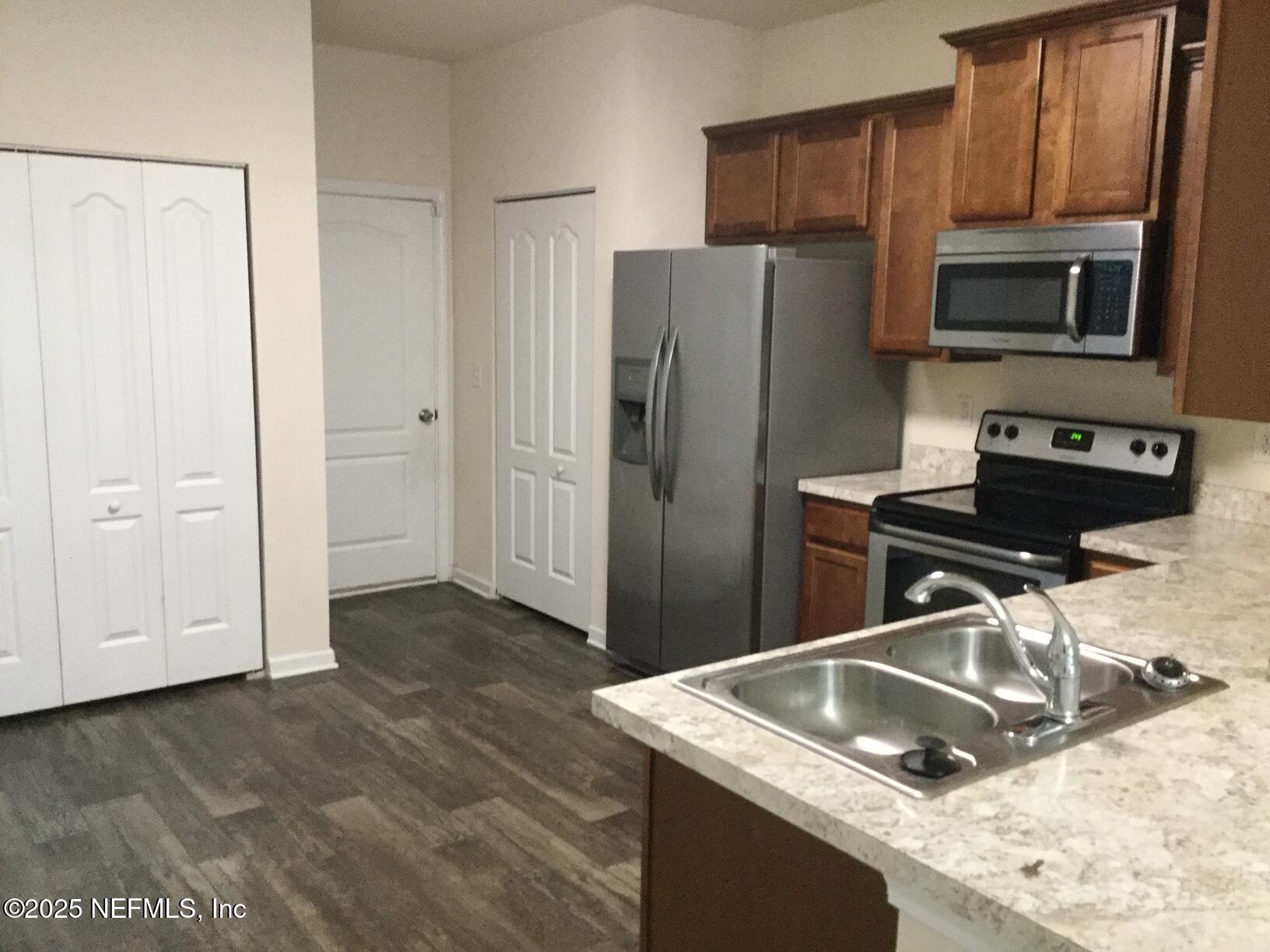 850 Servia Drive Jacksonville, FL 32259 - Photo 2 of 16 a kitchen with a sink stove and refrigerator