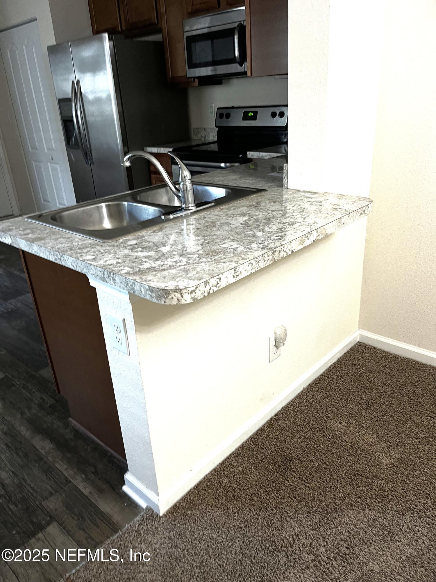 850 Servia Drive Jacksonville, FL 32259 - Photo 8 of 16 a kitchen with stainless steel appliances granite countertop a sink a stove and a refrigerator