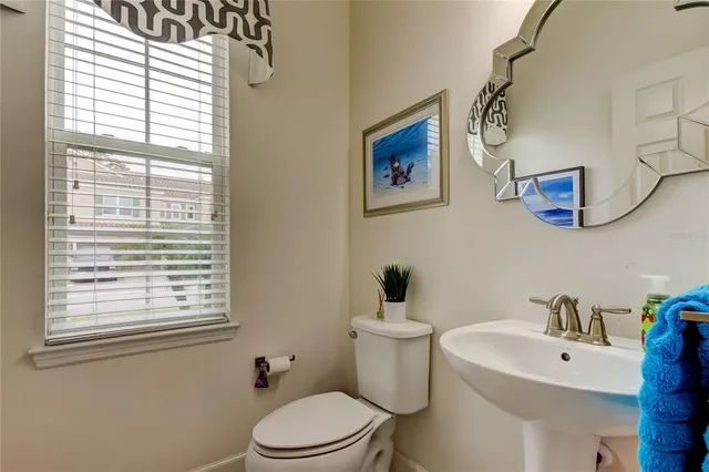 a white toilet sitting next to a bathroom sink