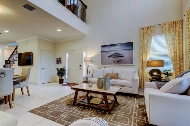 a living room with furniture a rug and a flat screen tv