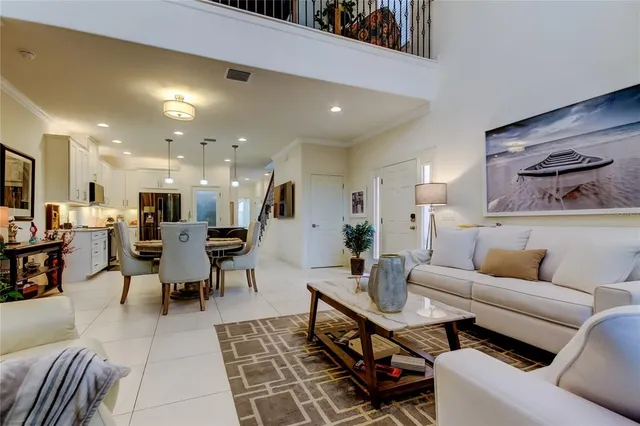 a living room with furniture and a dining table with kitchen view