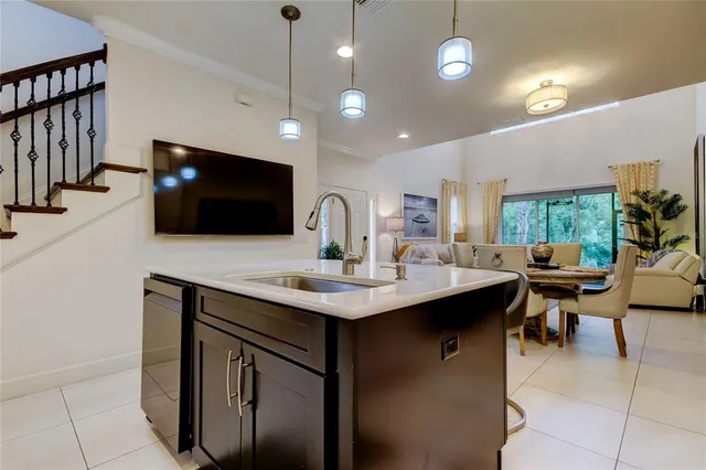 a kitchen with a sink stainless steel appliances and furniture