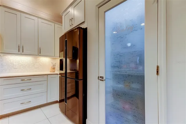 a kitchen with a refrigerator and cabinets