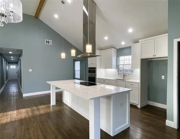 a large kitchen with a table and chairs