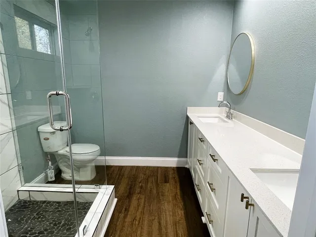 a bathroom with a toilet and a shower