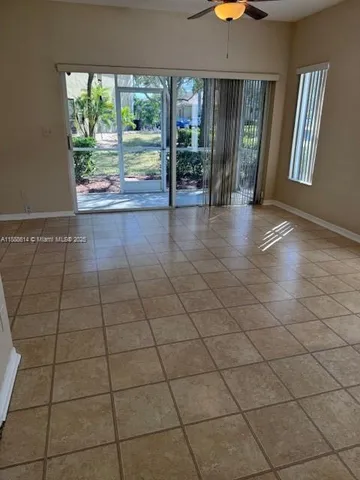 a view of an entryway with a floor to ceiling window and a fireplace