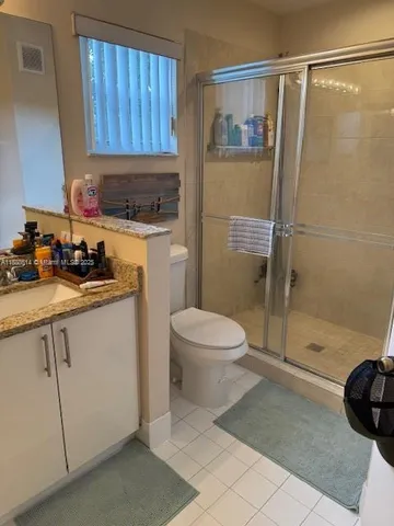 a bathroom with a shower a toilet and sink