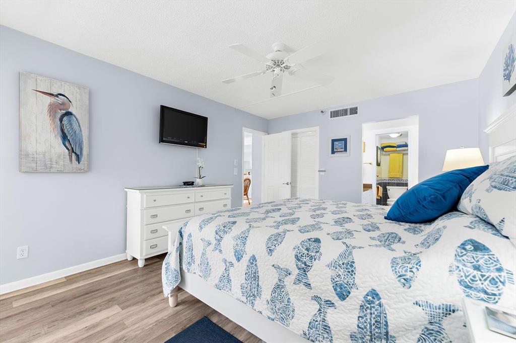 1551 Beach Road, Unit 207 Englewood, FL 34223 - Photo 16 of 40 a spacious bedroom with a bed and a flat screen tv