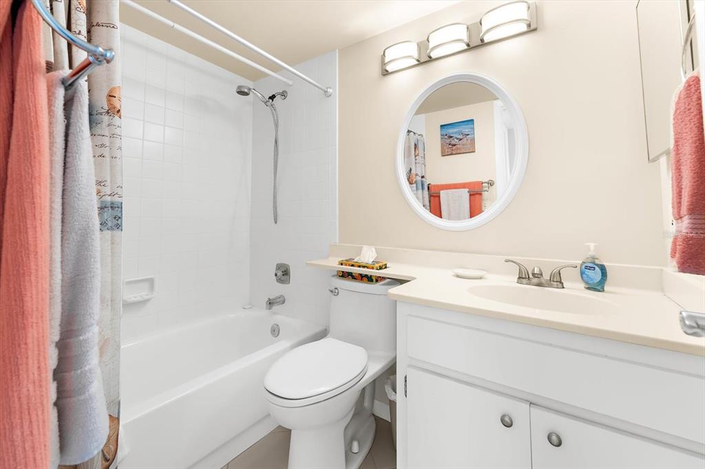 1551 Beach Road, Unit 207 Englewood, FL 34223 - Photo 20 of 40 a bathroom with a toilet sink vanity granite tub and shower