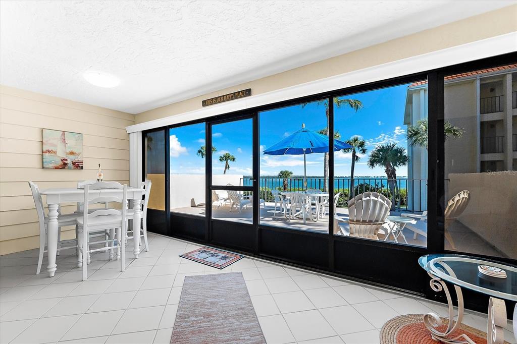 1551 Beach Road, Unit 207 Englewood, FL 34223 - Photo 23 of 40 a dining room with furniture and large windows