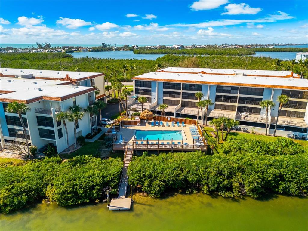 1551 Beach Road, Unit 207 Englewood, FL 34223 - Photo 35 of 40 an aerial view of a house with a garden and lake view