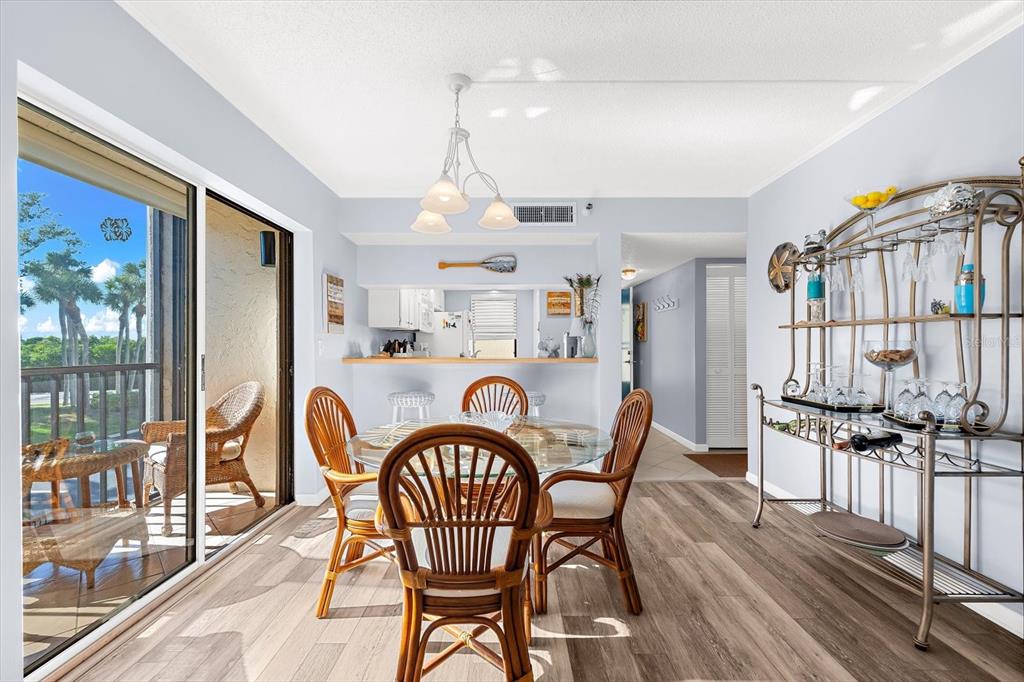 1551 Beach Road, Unit 207 Englewood, FL 34223 - Photo 9 of 40 a dining room with furniture and wooden floor