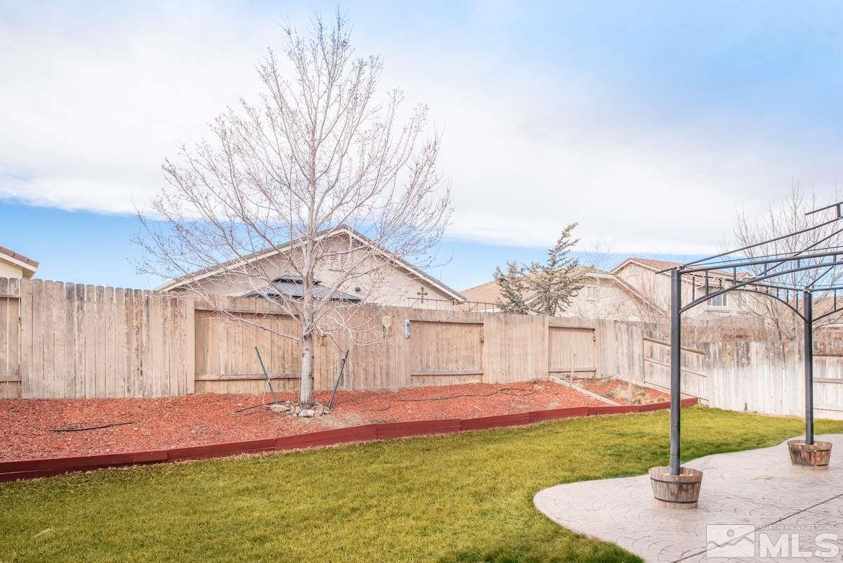 10041 Silver Star Drive Reno, NV 89521 - Photo 28 of 30 a front view of a house with a yard