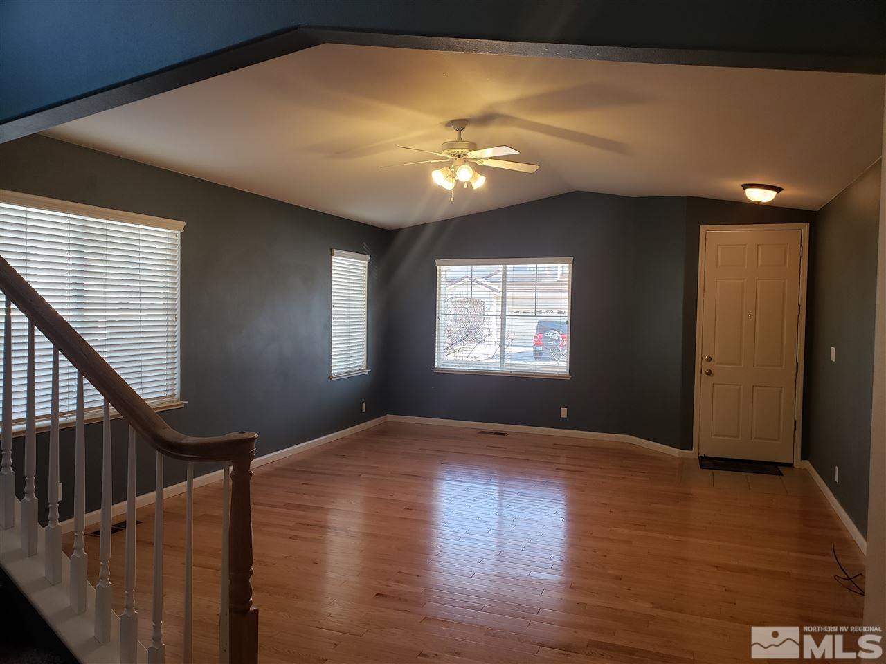 10041 Silver Star Drive Reno, NV 89521 - Photo 3 of 30 a view of an empty room with wooden floor and a window