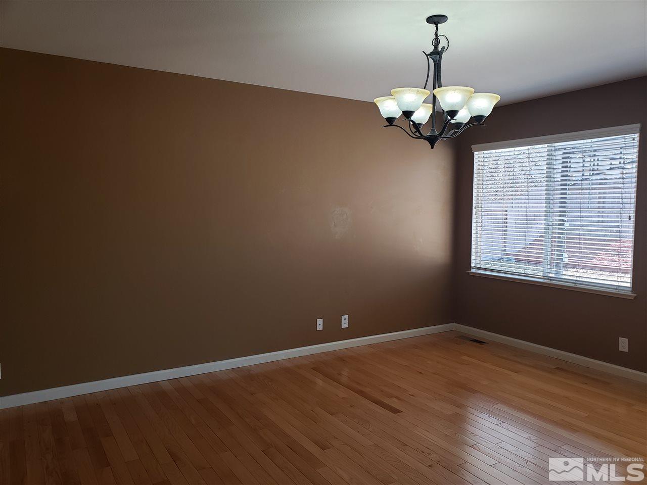 10041 Silver Star Drive Reno, NV 89521 - Photo 6 of 30 a view of wooden floor and chandelier in a room