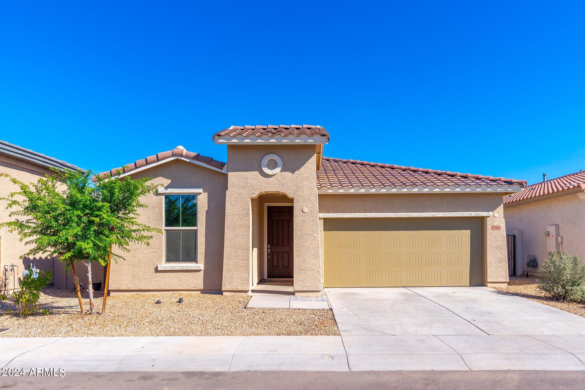 2764 West Apollo Road Phoenix, AZ 85041 - Photo 1 of 45 a front view of a house with garden