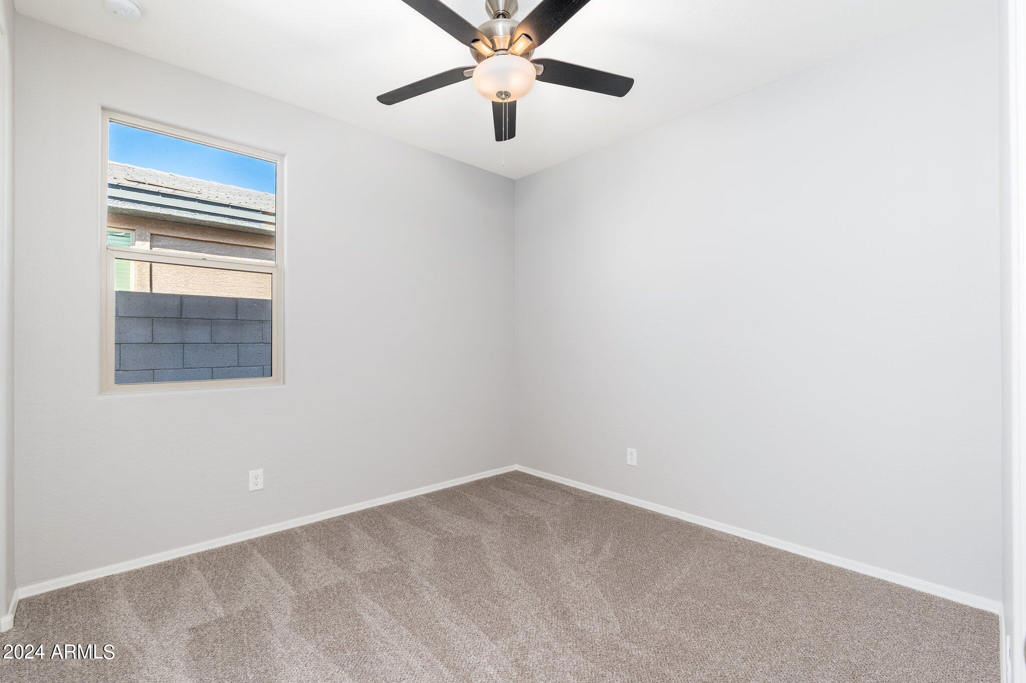 2764 West Apollo Road Phoenix, AZ 85041 - Photo 29 of 45 an empty room with a window and a fan