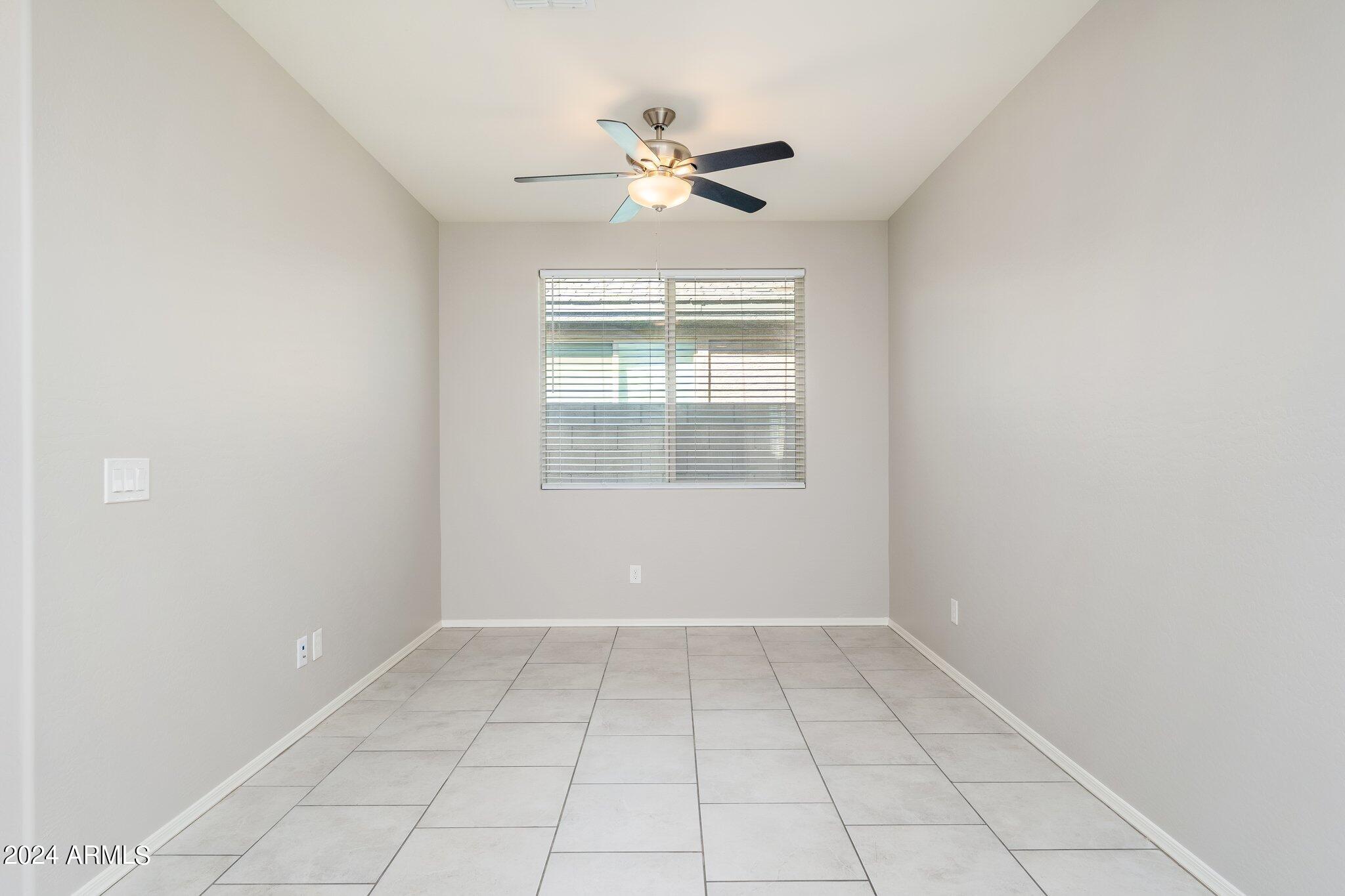 2764 West Apollo Road Phoenix, AZ 85041 - Photo 5 of 45 wooden floor in an empty room with a window